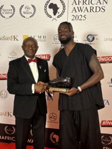 Super Eagles striker Tolu Arokodare with Vincent Kompany’s dad, Pierre Kompany after winning the African player of the year award in Belgium.